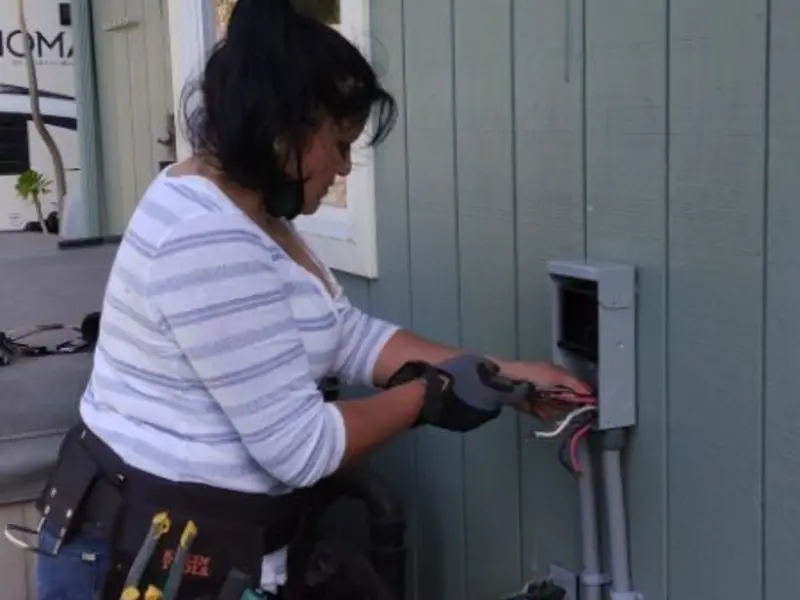 Licensed electrician wiring an exterior subpanel in Lyons